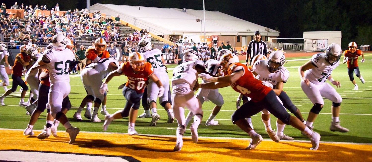The Mineola defense swarms Canton in the end zone to record a safety, take their first lead and shift all the momentum to the Yellowjackets. Hunter Wright (50) and Kobe Kendrick (24) led the charge.